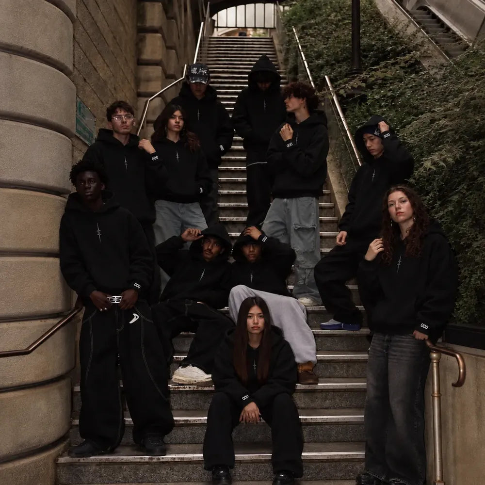NØR hoodies worn by a group on a stairway